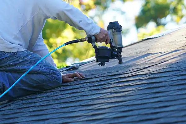 Roofer installing new shingles